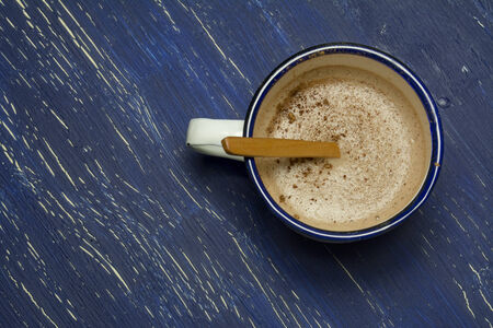 Hot chocolate in white metal cup on rustic background.  intense blue の写真素材