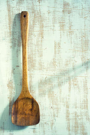 Wooden kitchenware on blue background, texture for menus and cooking needsの写真素材