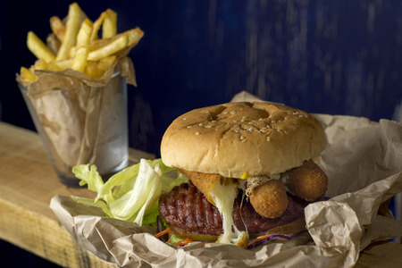 Hamburger, french fries in a paper wrapper , blue の写真素材