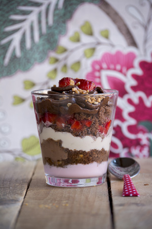 dessert, chocolate cream, yogurt, fresh strawberries and whipped cream on rustic wooden backgroundの写真素材