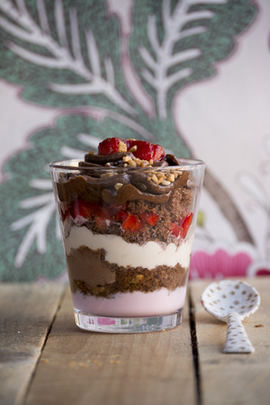 dessert, chocolate cream, yogurt, fresh strawberries and whipped cream on rustic wooden backgroundの写真素材