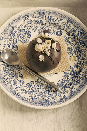 Round chocolate dessert with white chocolate chips and wafer  vintage style の写真素材
