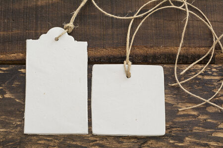 White labels, lace and rustic wooden background thread in geometric shapes の写真素材