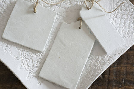 White labels, lace and rustic wooden background thread in geometric shapes の写真素材