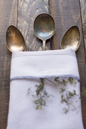 Vintage metal spoons on wooden table close-upの写真素材