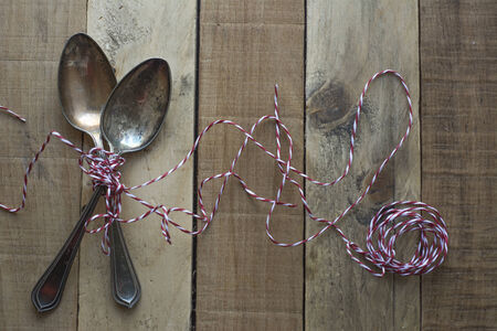 Vintage metal spoons on wooden table close-upの写真素材