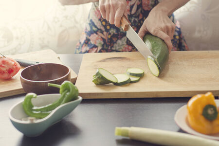 woman cooking healthy vegetables, vintage style imageの写真素材