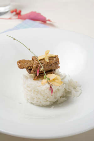 white rice with beef on wooden background