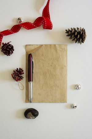 old paper, red ribbon and Christmas baublesの写真素材