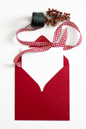 Red Envelope, Christmas letter, checkered red ribbon on white background and ornamentsの写真素材