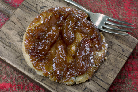 tarte tatin, on red background rustic
