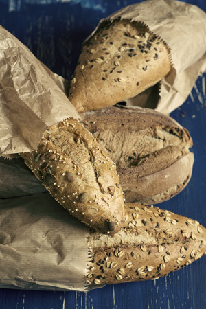 Variety of breads with seeds and nuts, on blue grunge の写真素材