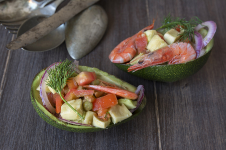 I vegetable salad with prawns, served on avocado shell halvesの写真素材