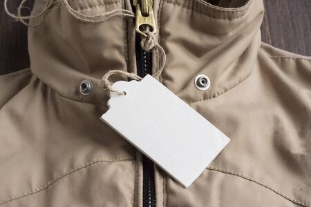 Price Tag on beige winter jacket with zipper closedの写真素材