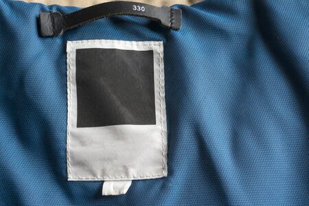 clothing label sewn on blue winter jacketの写真素材