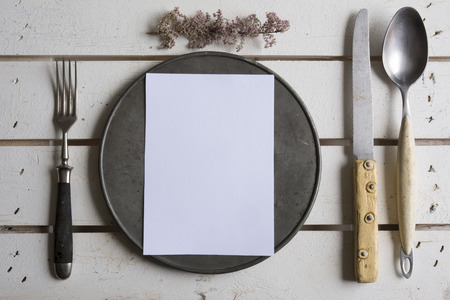 Rustic place setting menu on old white woodenの写真素材
