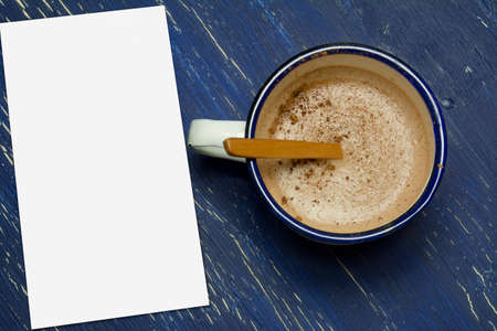 Hot chocolate in white metal cup on rustic background.  intense blueの写真素材