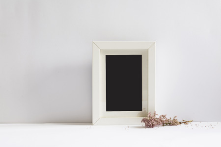 empty picture frame, decorated with pink flowers, white backgroundの写真素材