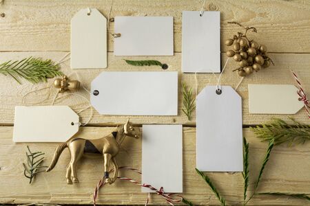 Set of empty paper price tags, wooden backgroundの写真素材