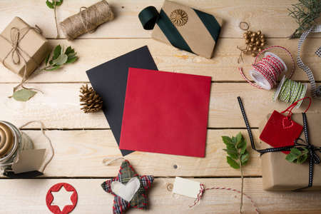 empty greeting cards and Christmas ornaments on wooden background