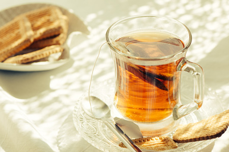 healthy cup of hot tea on breakfast table, with morning light