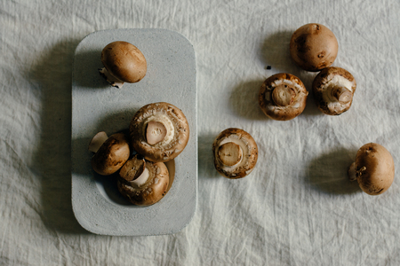 Fresh raw mushrooms, in blue Stone table , portobello variety, from aboveの写真素材