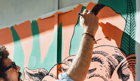 MADRID, SPAIN - APRIL 23, 2017: Artist in the event Paint Malasana! Artists, illustrators and graphic designers, painting with color, in the streets of the District of Malasa  There are 100 selected artists to paint in 100 shutters, wooden doors, crystalsのeditorial素材