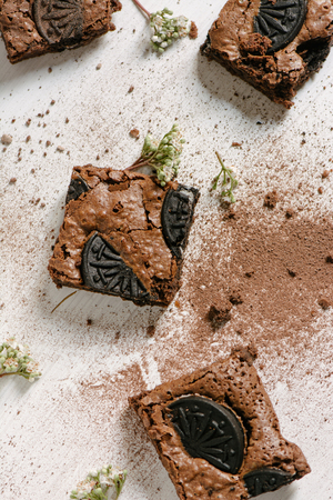 Chocolate brownies, with black biscuit stuffed with cream, stacked from aboveの写真素材