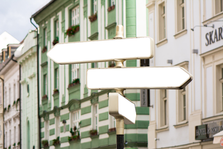 Blank guide post in the city, behind, building with classical architecture. 3 empty rectangular postersの写真素材