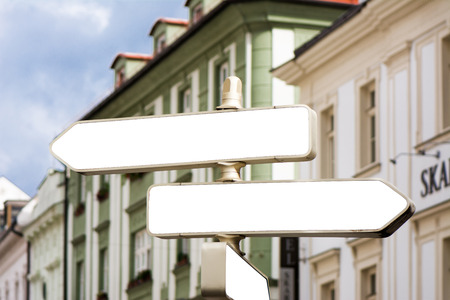 Blank guide post in the city, behind, building with classical architecture. 3 empty rectangular postersの写真素材