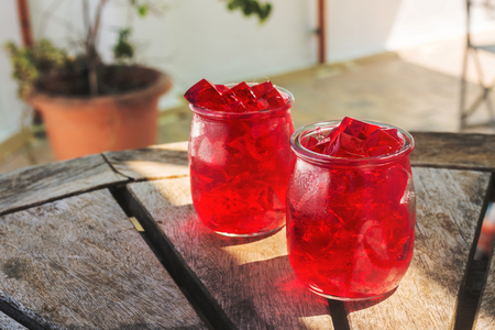 red jelly, cut into dice, inside two glasses of glass, on the table. outdoorの写真素材