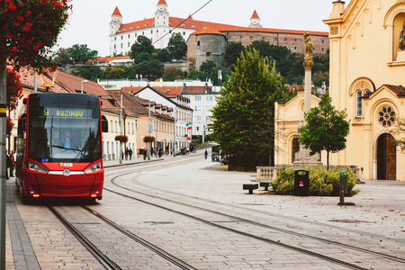 BRATISLAVA, SLOVAKIA - SEPTEMBER 30, 2016: Modern Tram in the historic center ,view of the Bratislava castle, in the background.のeditorial素材