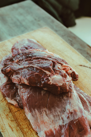 Delicious raw thick skirt steak, in the wooden board. Argentine court very consumed in barbecuesの写真素材