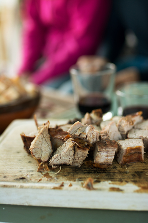 grilled meat cut into slices, on wooden boardの写真素材