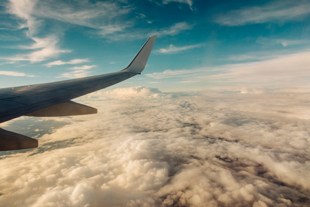 Clouds and sky as seen through window of an aircraftの写真素材