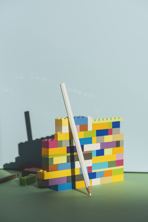Pencil leaning against the colorful brick Back to school conceptの写真素材