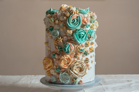 Cake decorated with Swiss meringue in the shape of flowers, pastel colors.の写真素材