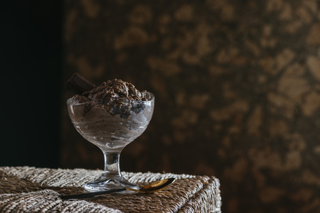 Chocolate mousse in glass cup, on wicker table. mystic light foodの写真素材