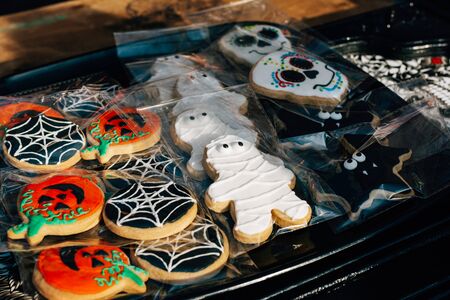 Fun halloween cookies, in an outdoor market. orange and black colorsの写真素材