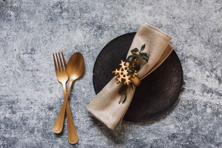 christmas table setting, golden cutlery and nandinas, on grunge table. Holiday dinnerの写真素材