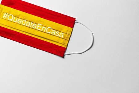 COVID-19, QuedateEnCasa. surgical mask with the Spain flag showing the messageの写真素材