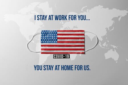 Covid-19. Surgical mask with the United States flag showing the messageの写真素材
