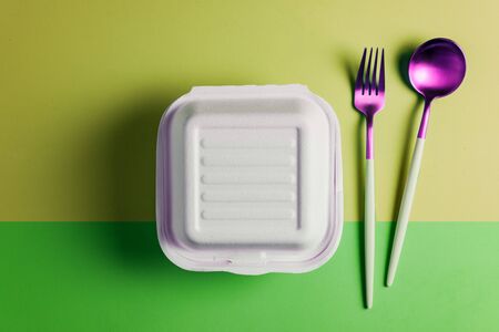 Healthy food concept: white burguer packaging closed with retro fork and spoonの写真素材