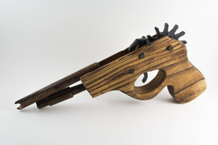 Classical Rubber Band Launcher Wooden Pistol Gun on white isolated backgroundの写真素材
