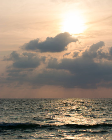 dramatic sunset at the sea with beach foregroundの写真素材