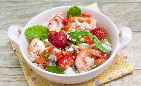 Strawberry salad with fresh berries on wood backgroundの写真素材