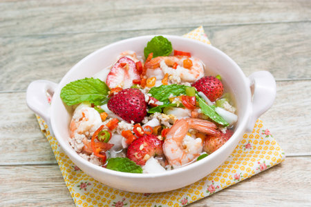 Strawberry salad with fresh berries on wood backgroundの写真素材