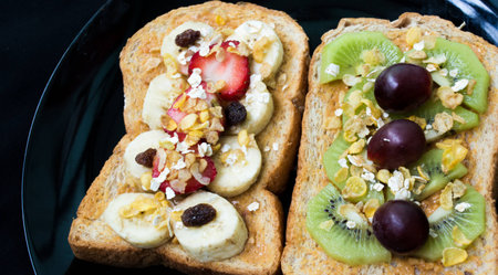 Grain breads peanut butter with fruit on dishの写真素材