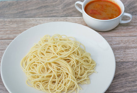 spaghetti with tomyum soup on wood backgroundの写真素材
