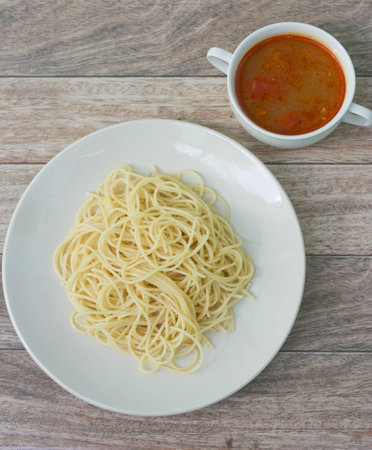 spaghetti with tomyum soup on wood backgroundの写真素材